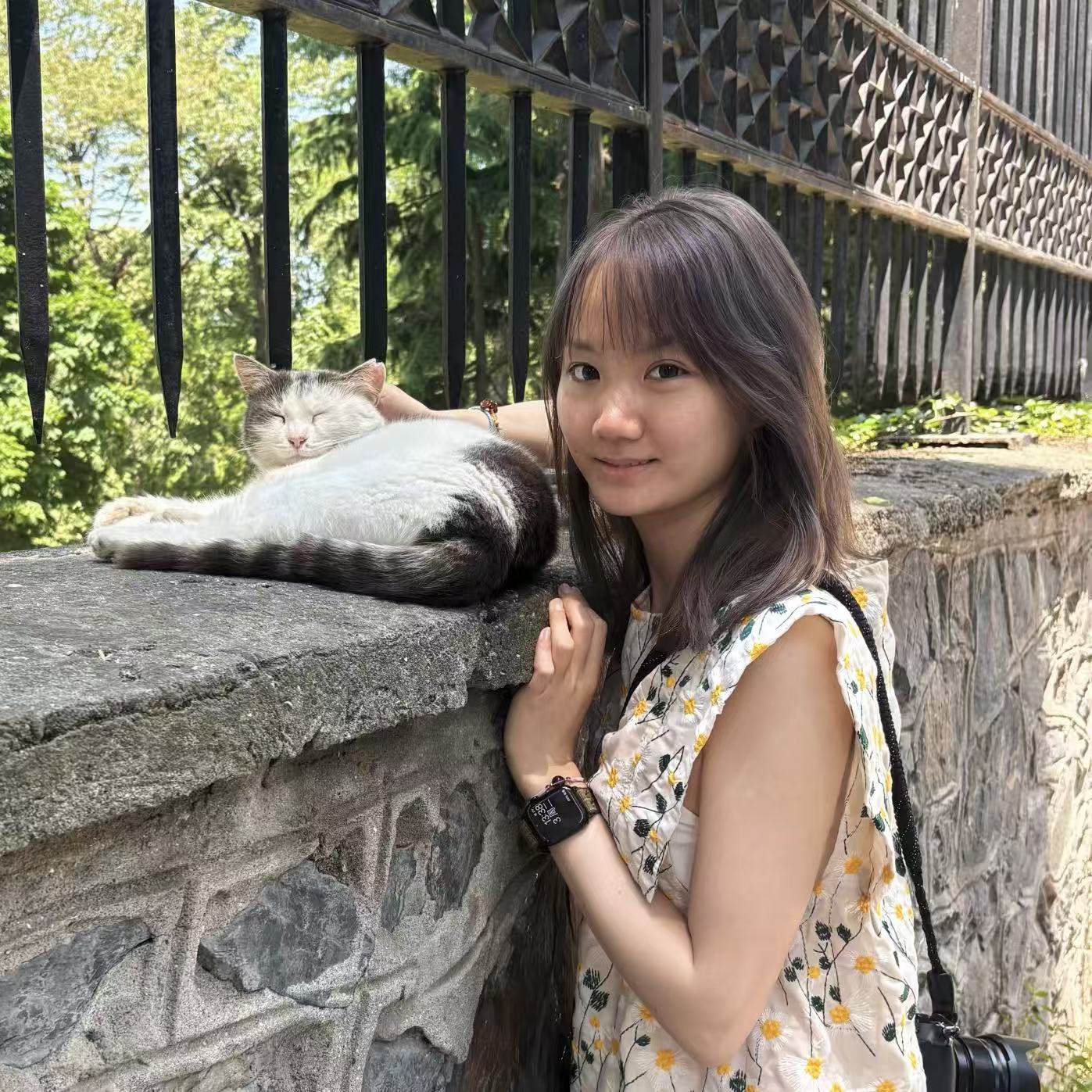 Ziliang Qiu beside a cat outdoors